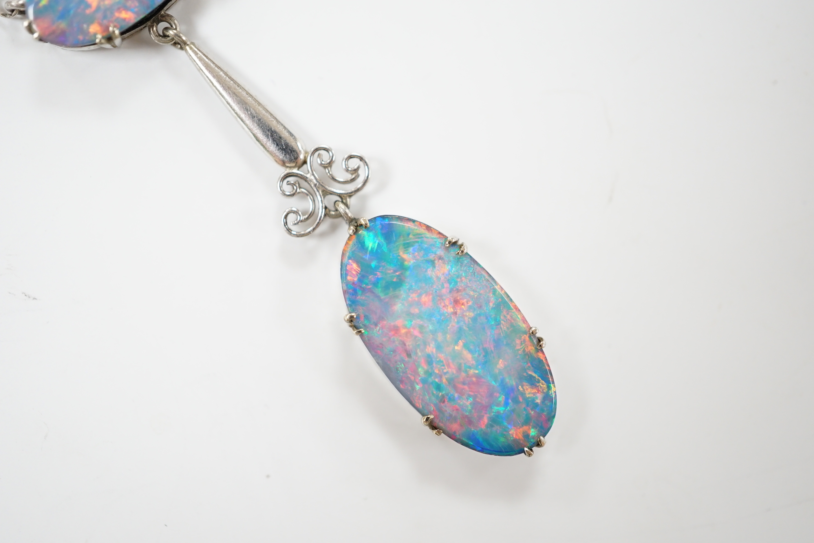 A 1920's style 9ct white metal and two stone black opal doublet set drop pendant necklace, overall 58cm, gross weight 4 grams.